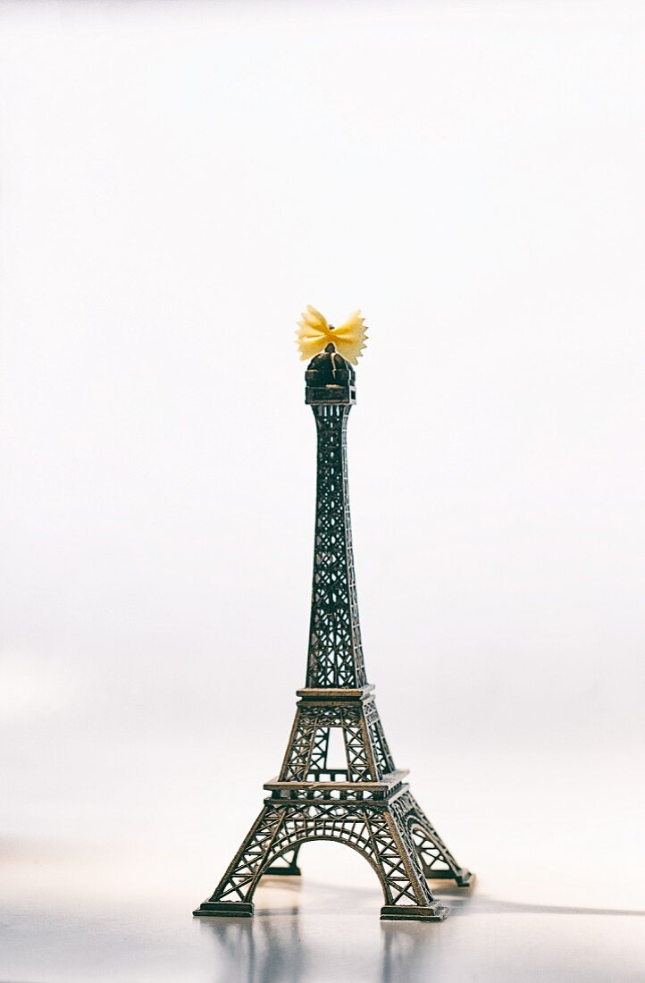 The Eiffel Tower with a farfalle bow on the top to symbolise France and Italy