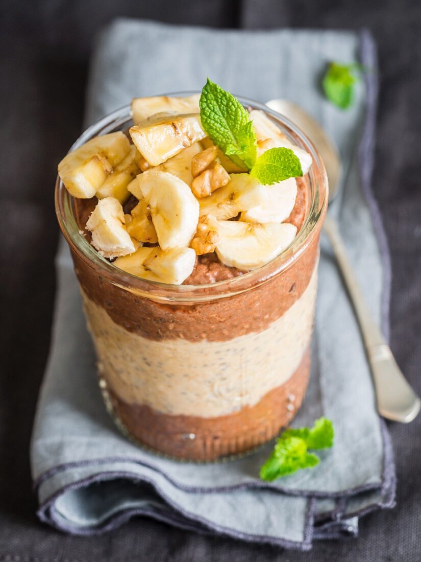 Layered chocolate peanut butter wiht chia pudding and banana