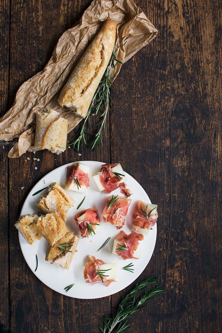 Baguette slices topped with ham and melon