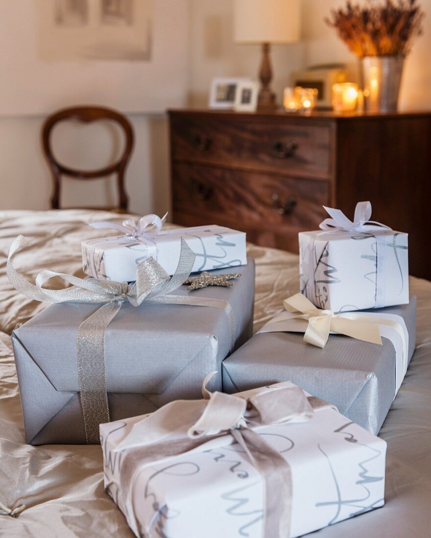Presents wrapped in grey, silver and white in bedroom