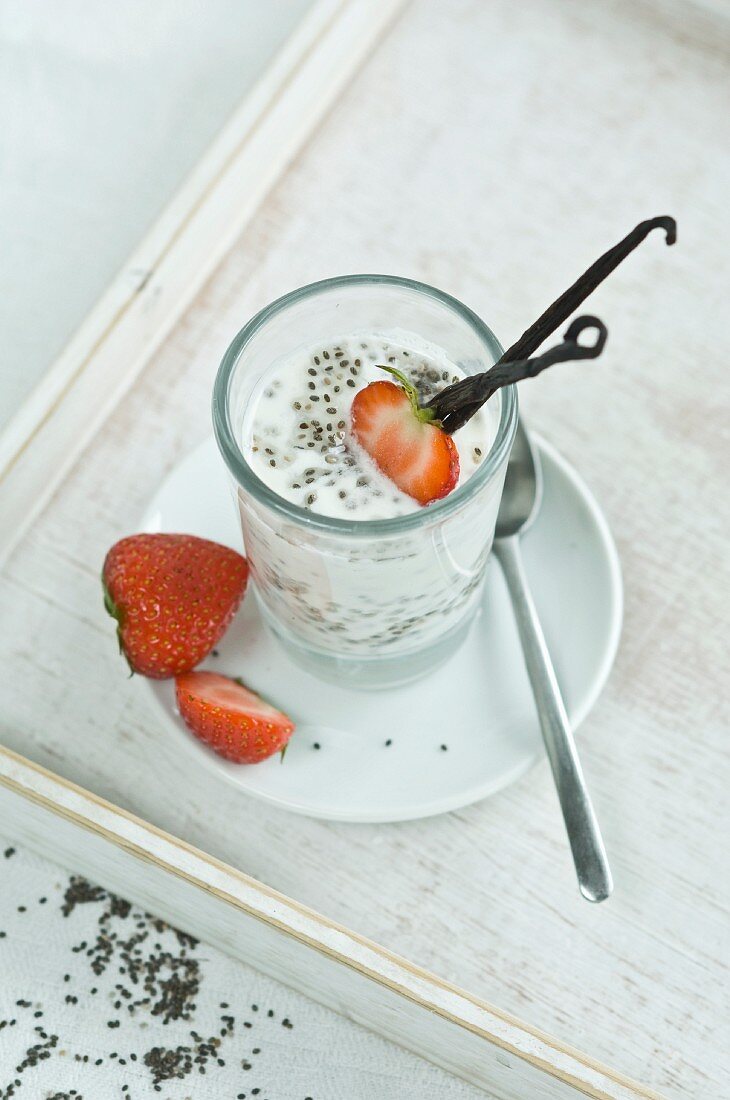 Chia pudding with fresh strawberries and vanilla bean in glass