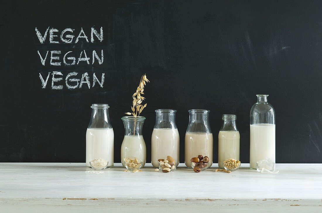 Glass bottles of various vegan milks