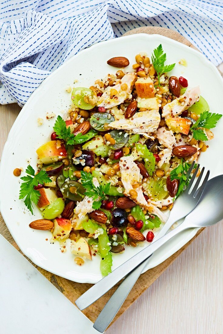 A chicken and corn salad with fruit and almonds