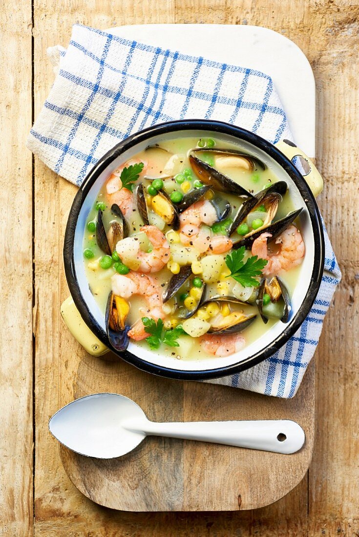 Shrimp chowder with mussels, corn and peas