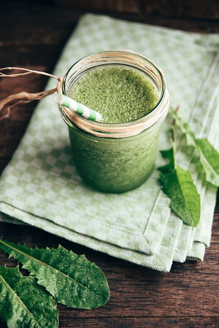 Green smoothie with dandelion, banana and apple juice