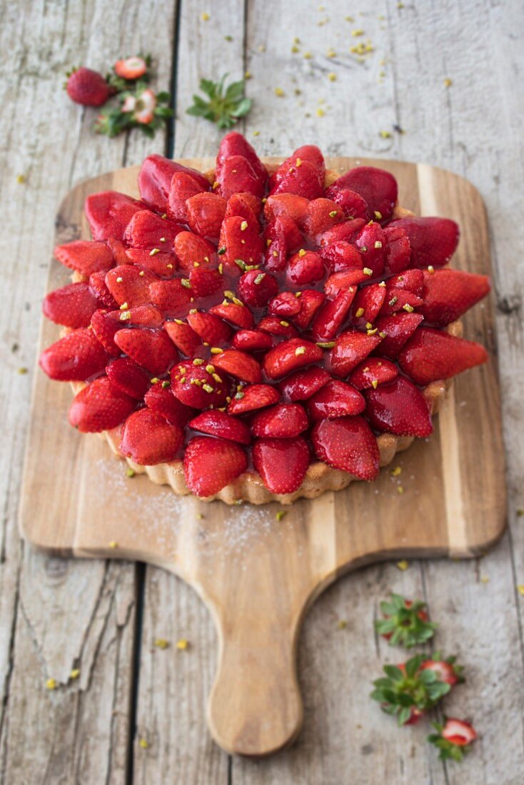 Strawberry tart on a chopping board