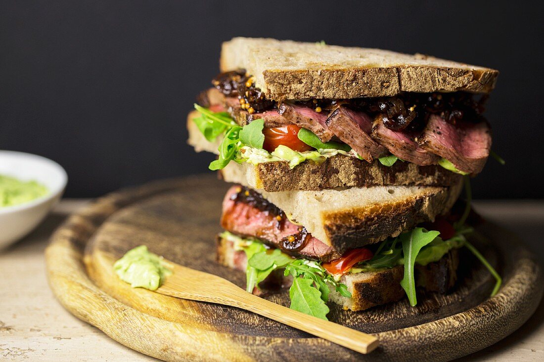 A steak sandwich with wild garlic mayonnaise, balsamic onions, tomatoes and rocket