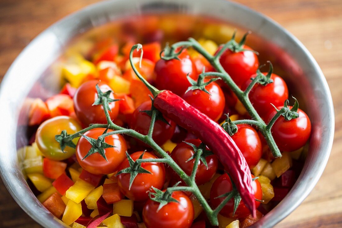 Tomatoes and chillies on chopped peppers