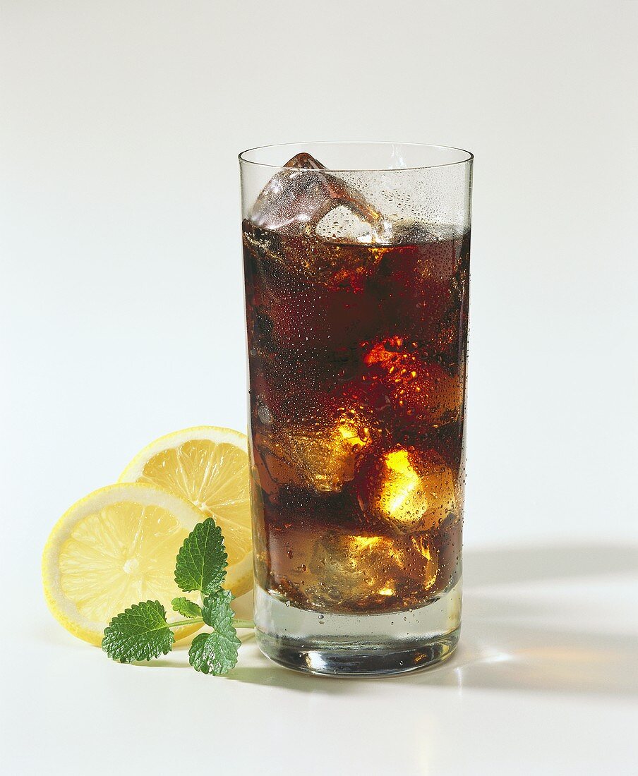 A Glass of Coke with Ice Cubes; Lemon Slices