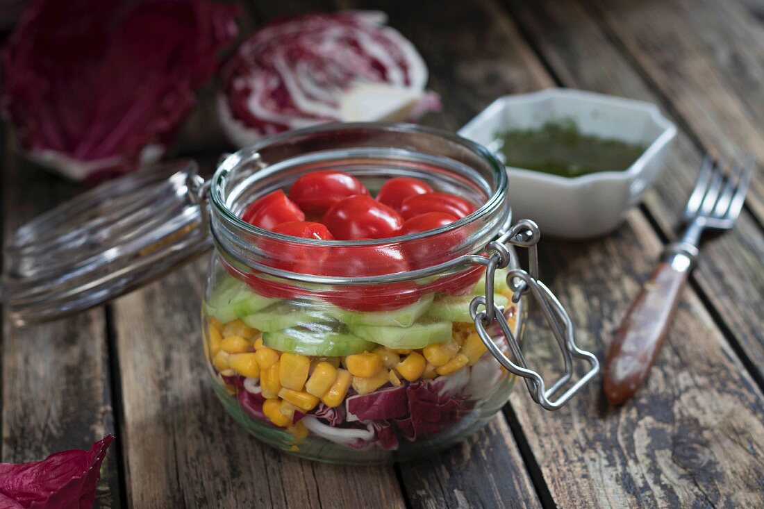 Salat mit Tomaten, Gurken, Mais und Radicchio im Weckglas