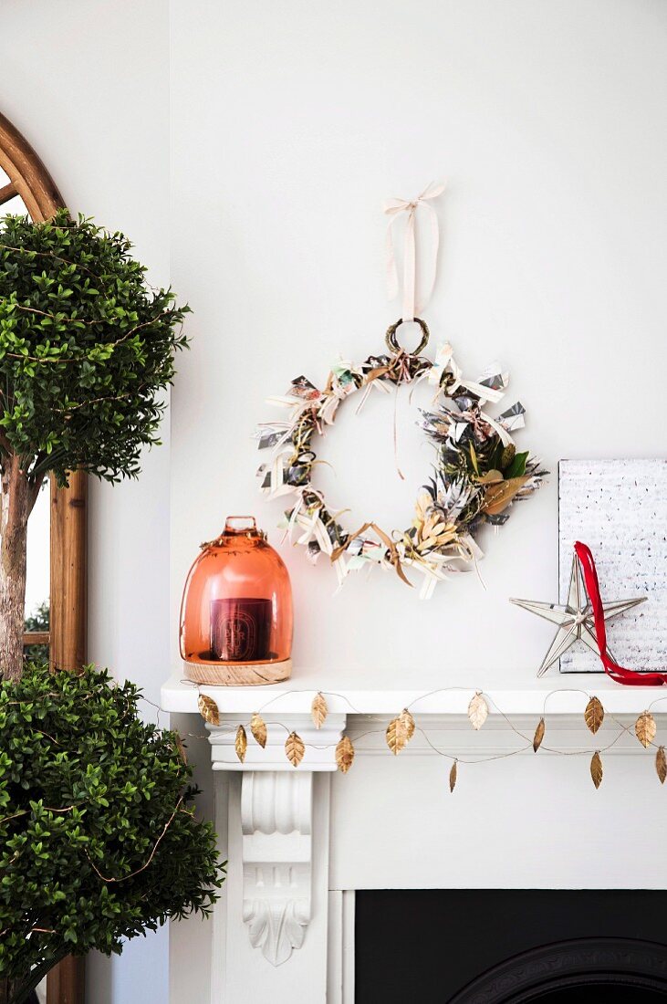 Paper wreath and ribbon on the wall above the fireplace