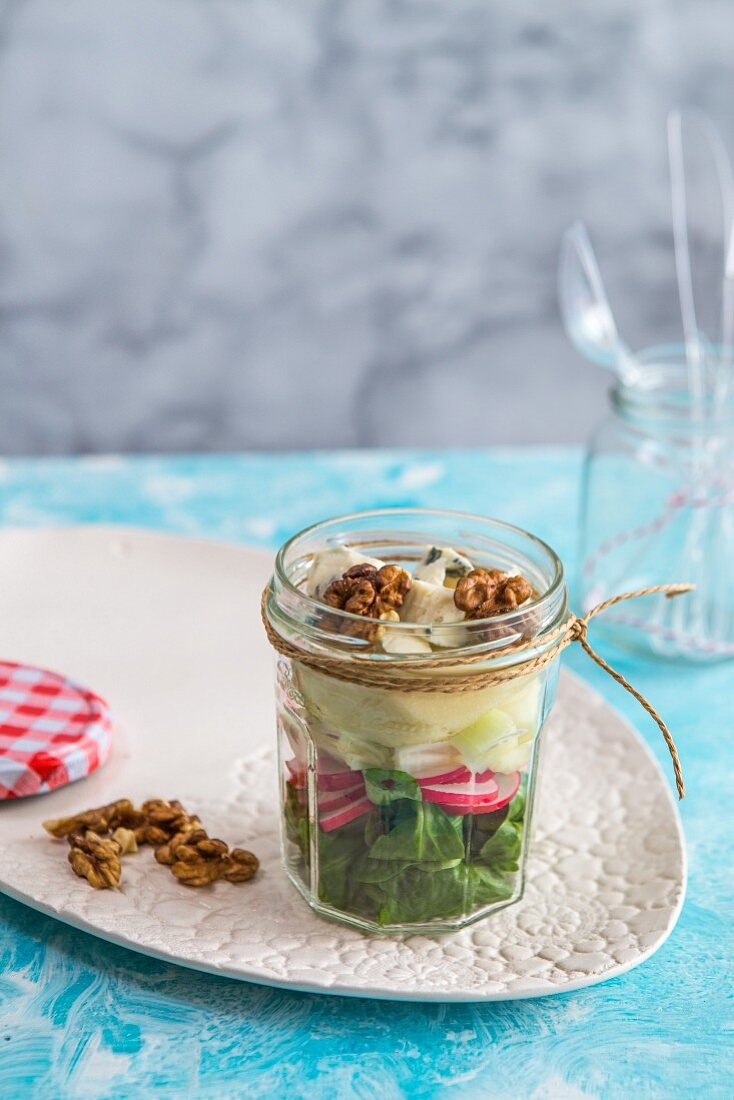 Lamb's lettuce with gorgonzola, pear and walnuts in a glass jar