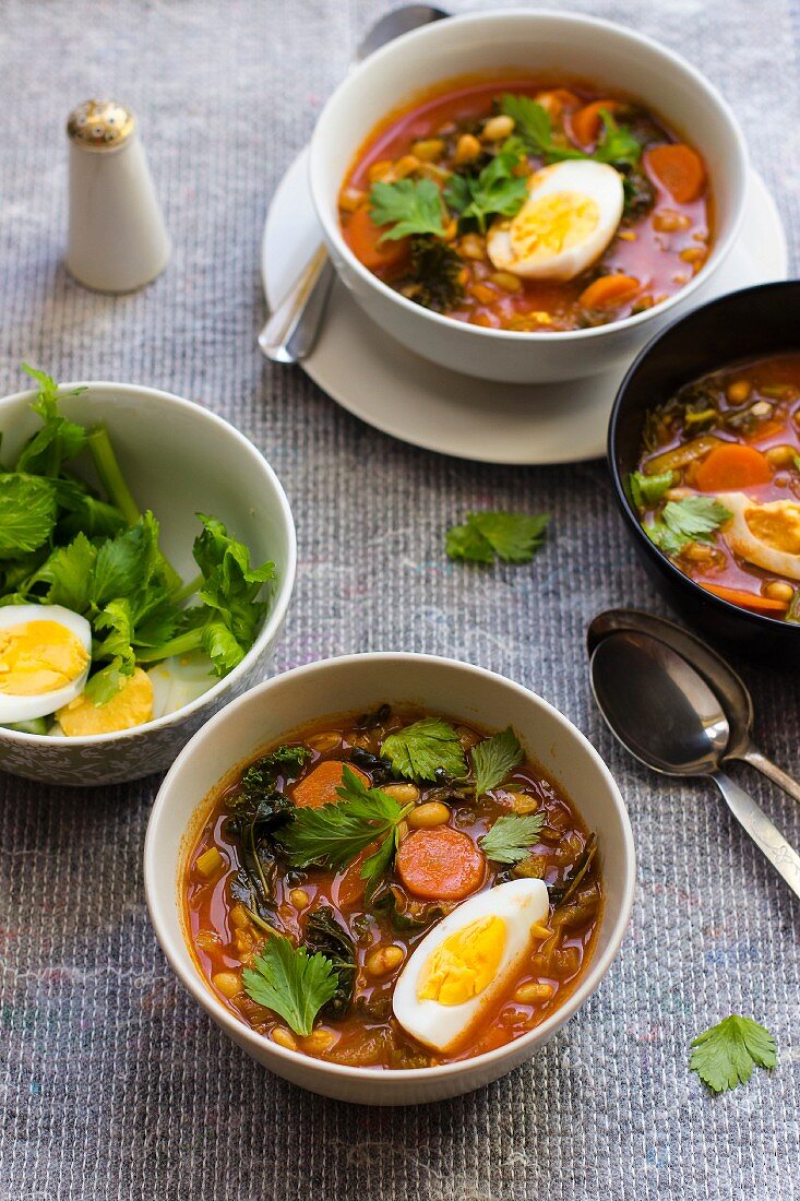 White bean soup with harissa, honey, egg and celery leaves