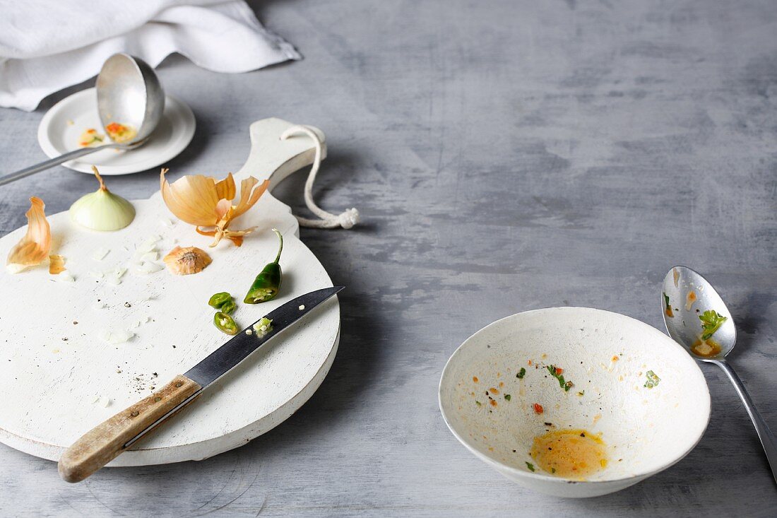 An empty soup bowl and vegetable waste