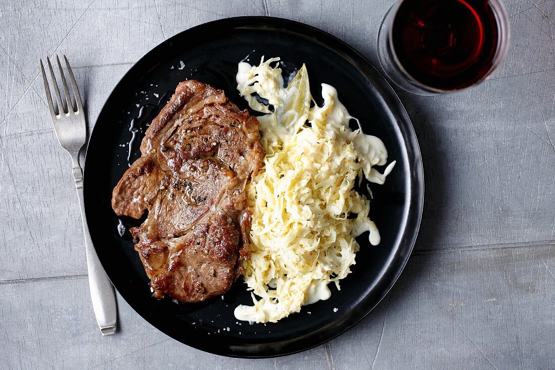 Fried rib-eye steak with creamy sauerkraut