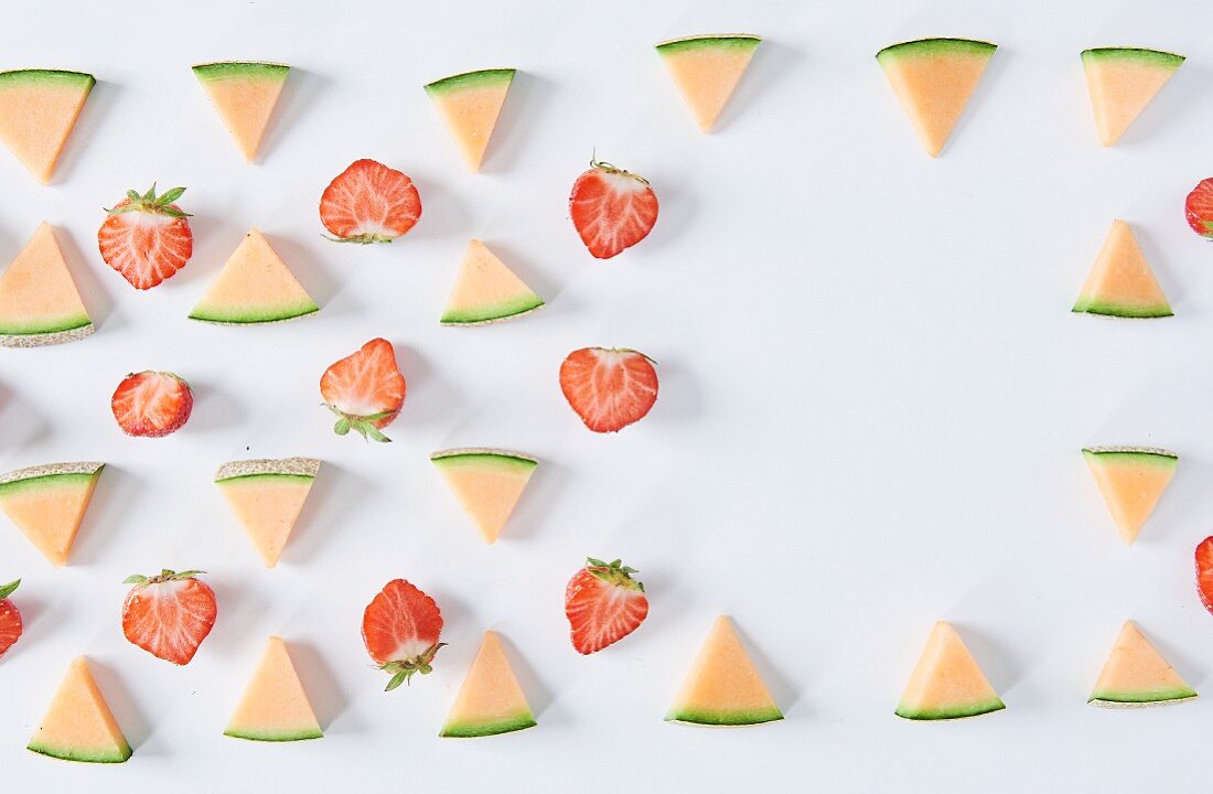 Halved strawberries and melon triangles