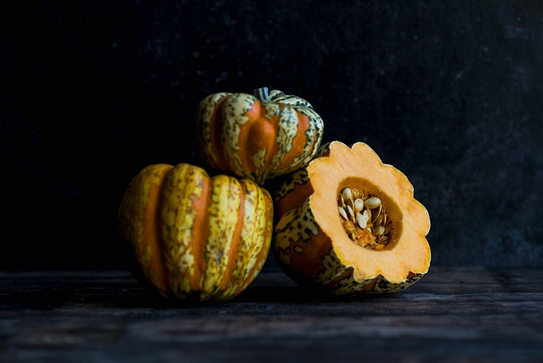 Three heirloom pumpkins, whole and halved