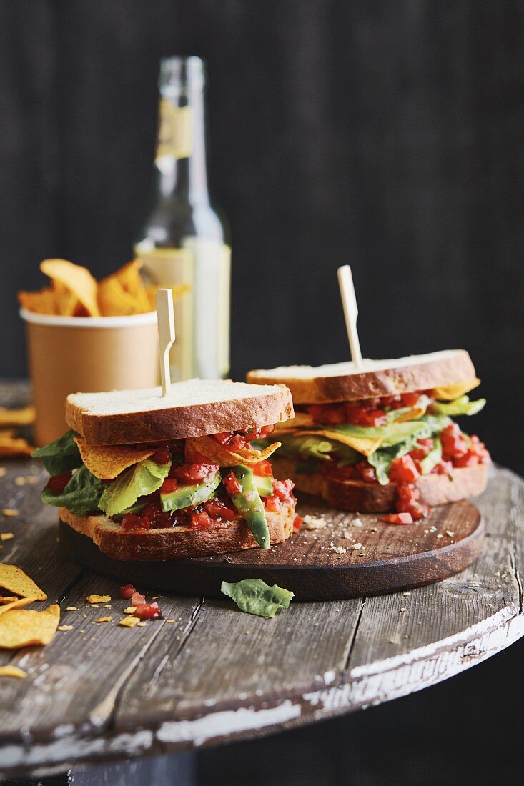 Sandwiches with avocado, tortilla chips and redcurrant salsa