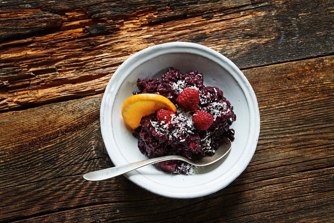 Black rice pudding with raspberries