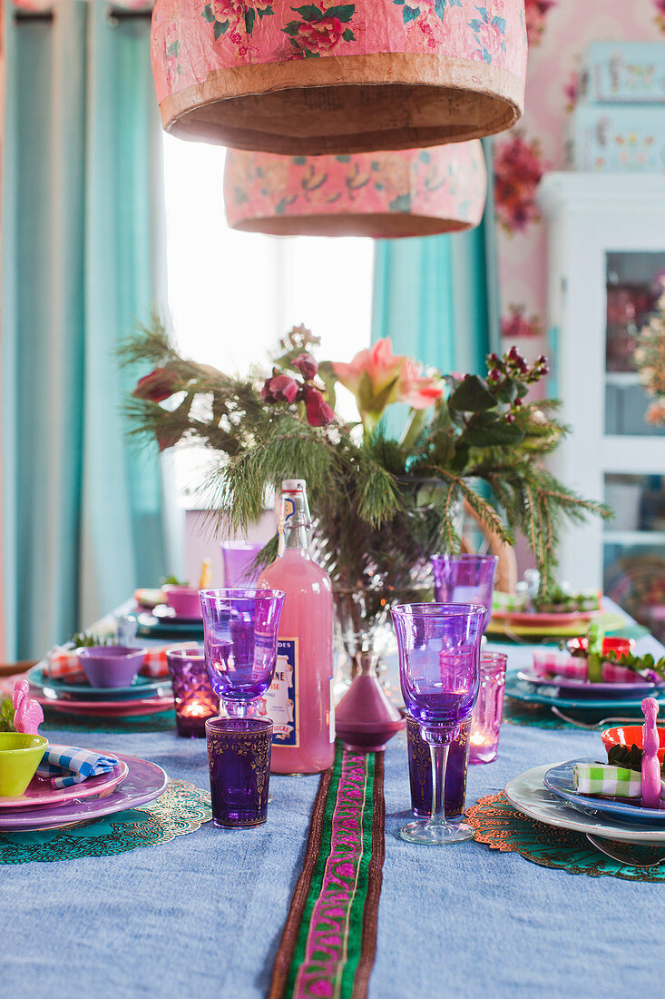 Table set with brightly coloured Oriental Christmas decorations