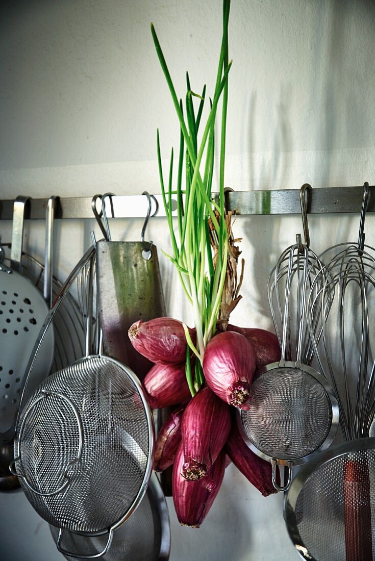 Red Tropea onions on a hook rack