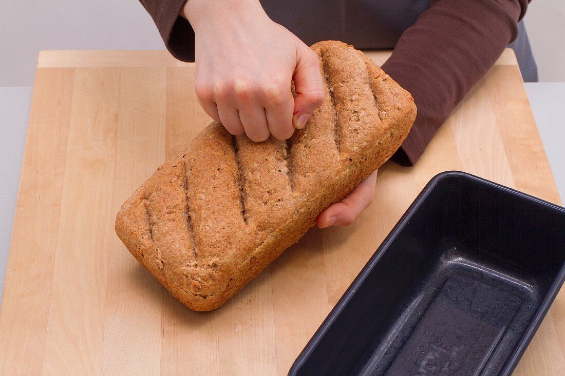 Testing a bread loaf - when fully baked, the loaf should sound hollow