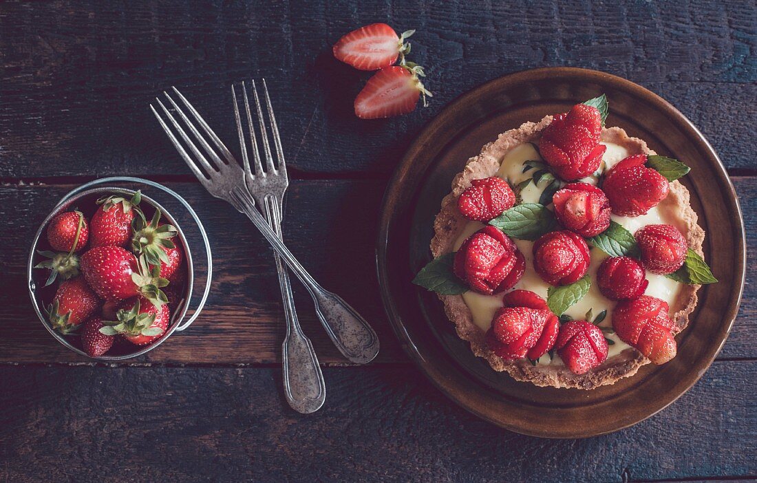A homemade tart with strawberries and vanilla pudding