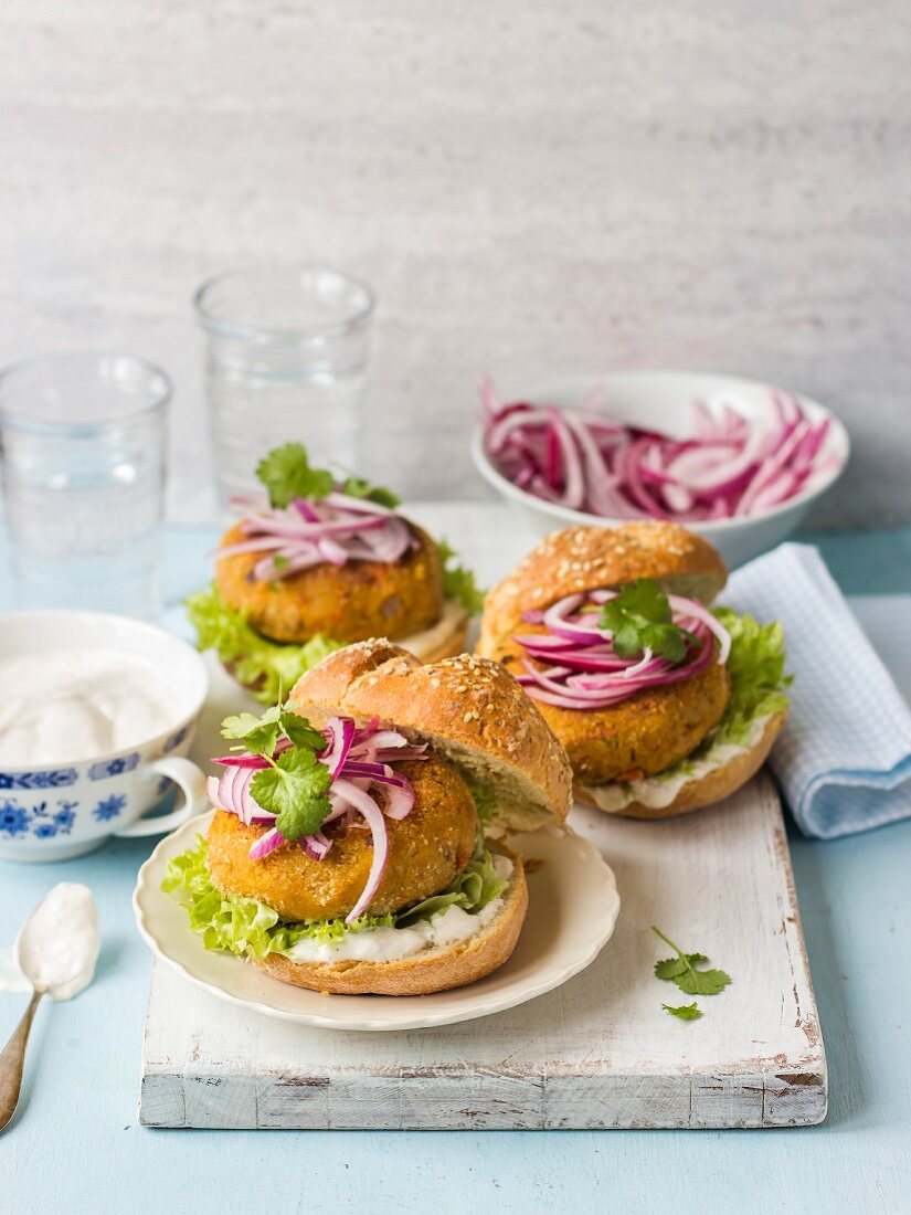 Carrot and chickpea burgers with red onion, coriander and lettuce