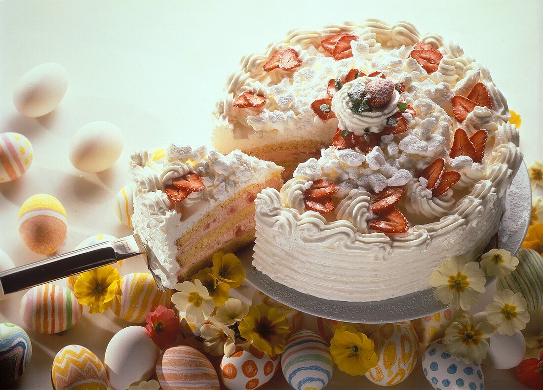 Easter cake with rhubarb and strawberry cream, a piece cut