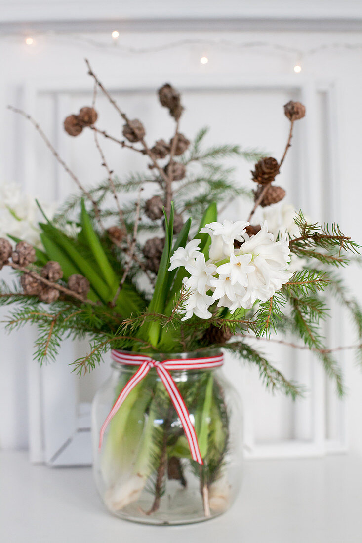 Wintry bouquet with white hyacinths, larch branches and fir branches