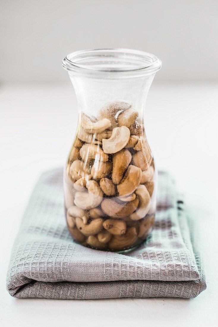 Soaked cashew nuts in a glass karaffe