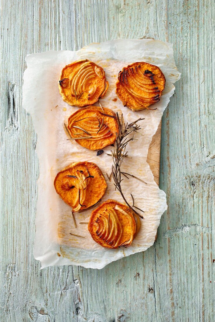Baked sweet potato slices with onions and rosemary