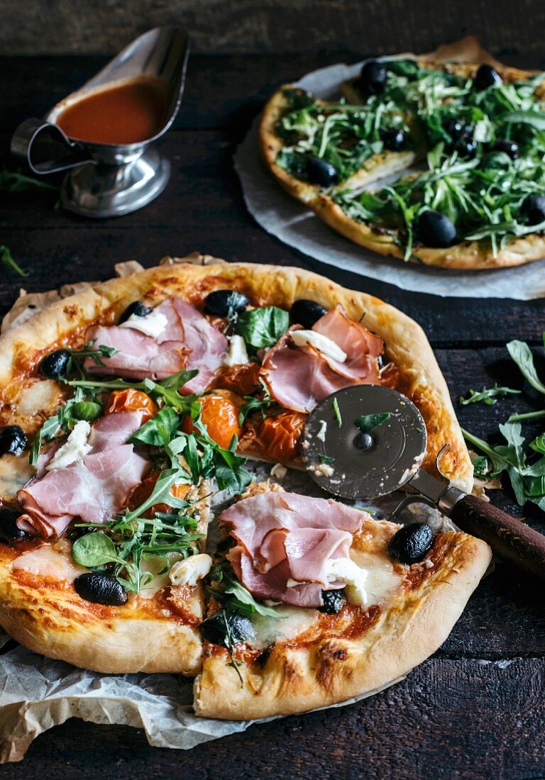 Served and sliced pizza with ham and mozzarella cheese