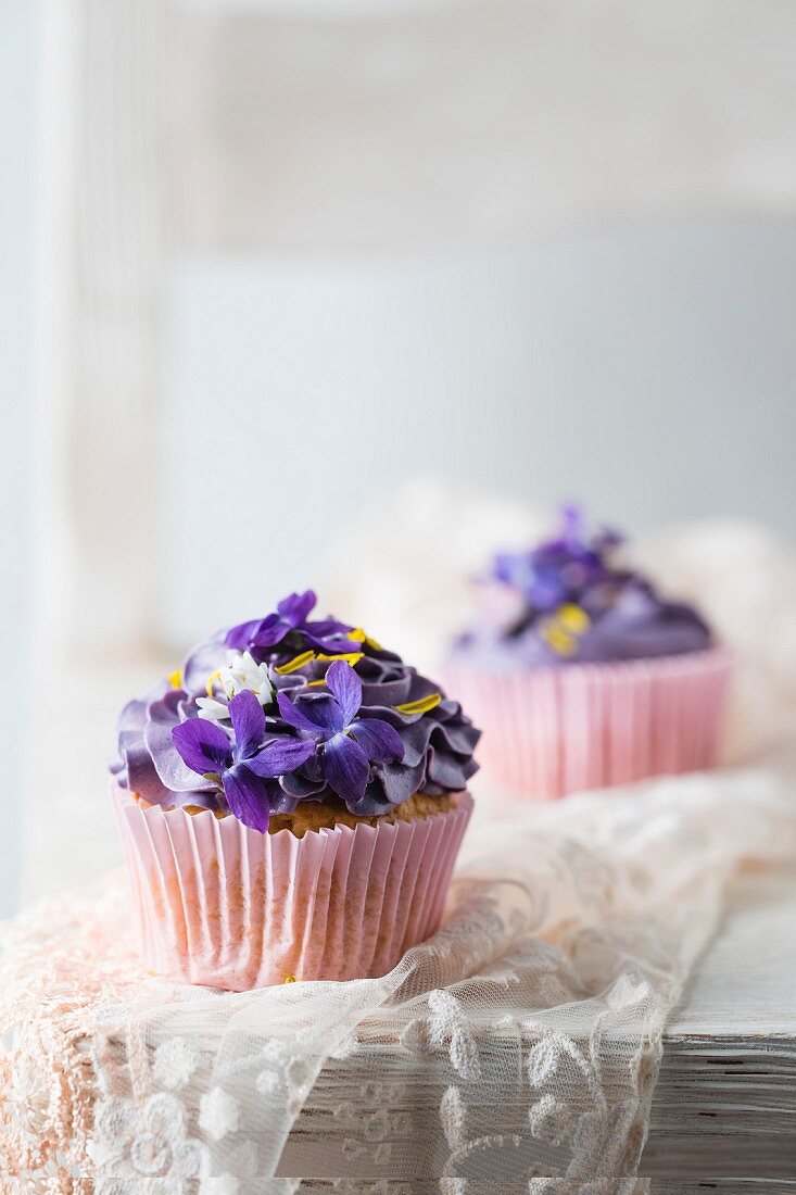 Cupcakes with violets, daisies, and dandelion petals