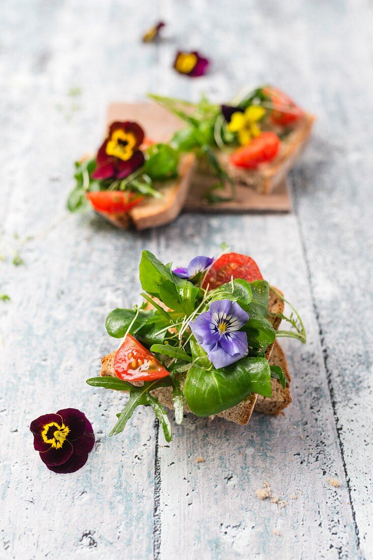 Open sandwiches topped with a spring salad