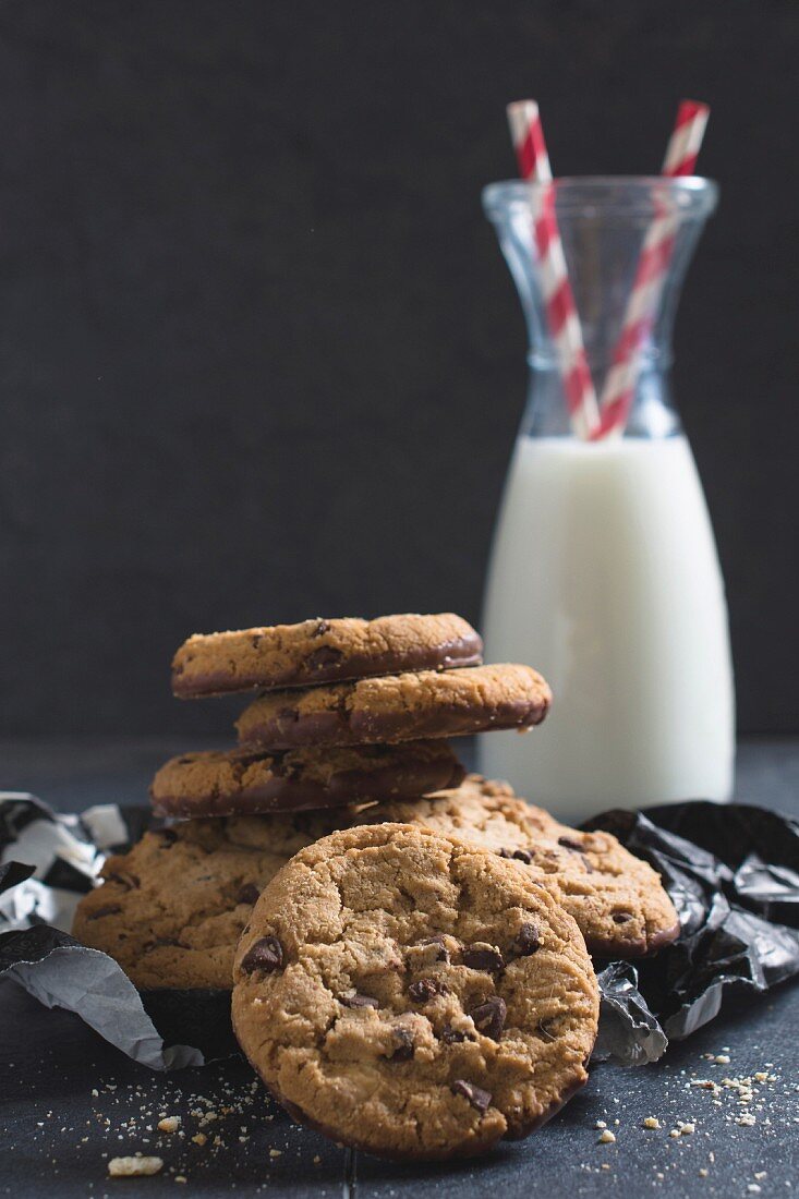 Sweet homemade chip cookies and bottle of milk, selective focus