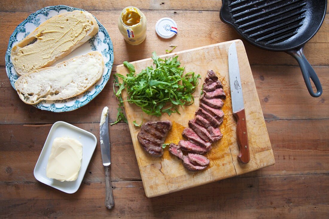 Fried, sliced beef steak with sourdough, mustard and butter