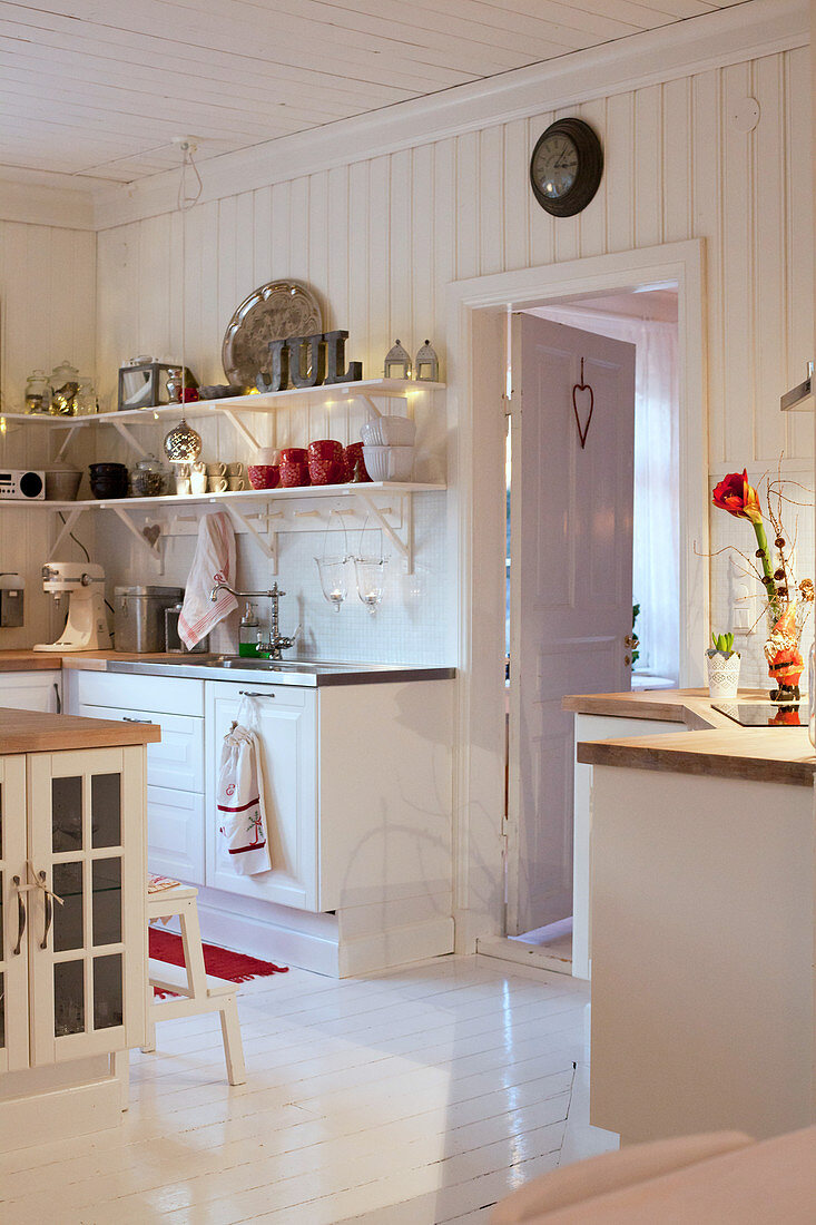 Christmas decorations in country-house kitchen decorated entirely in white