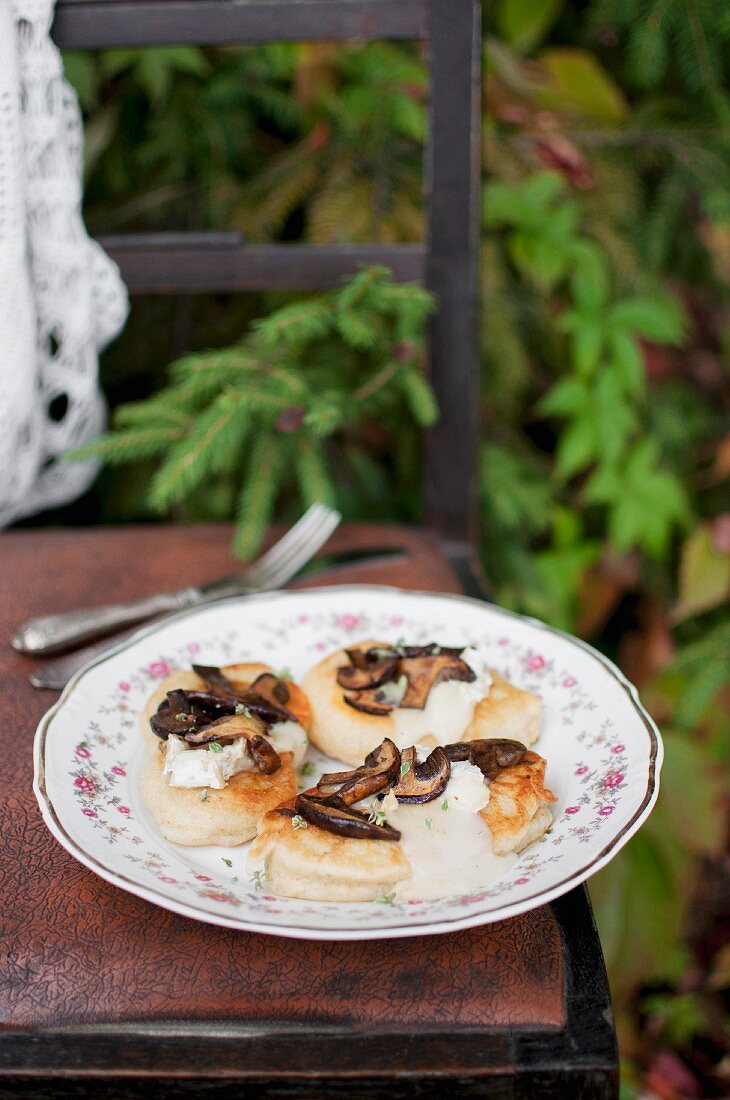 Blinis (Russian pancakes made from buckwheat flour) served with feta and wild mushrooms