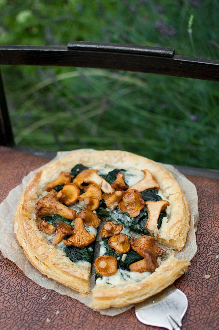 A puff pastry tart with spinach, gorgonzola and chanterelle mushrooms