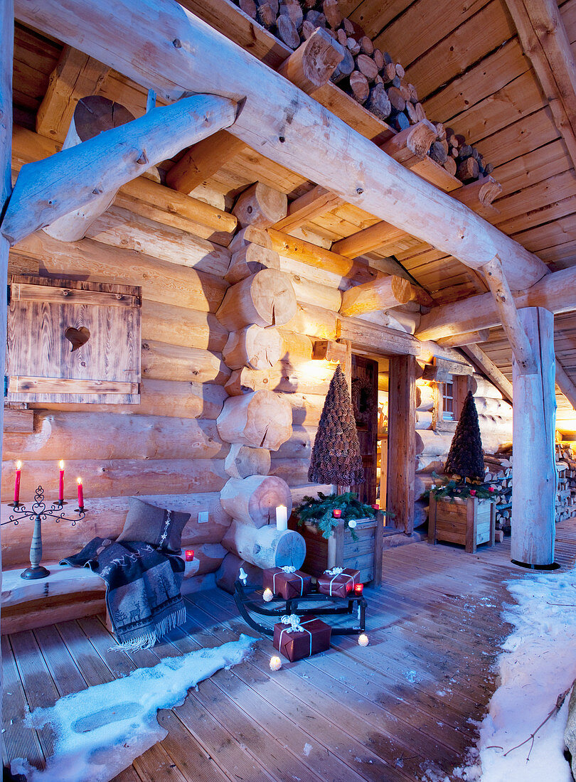 Festively decorated and illuminated snowy veranda