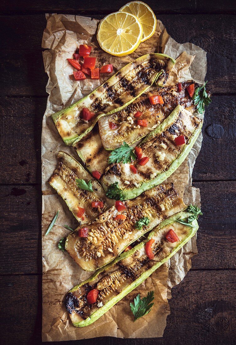 Juicy grilled zucchini with spices on the wooden table