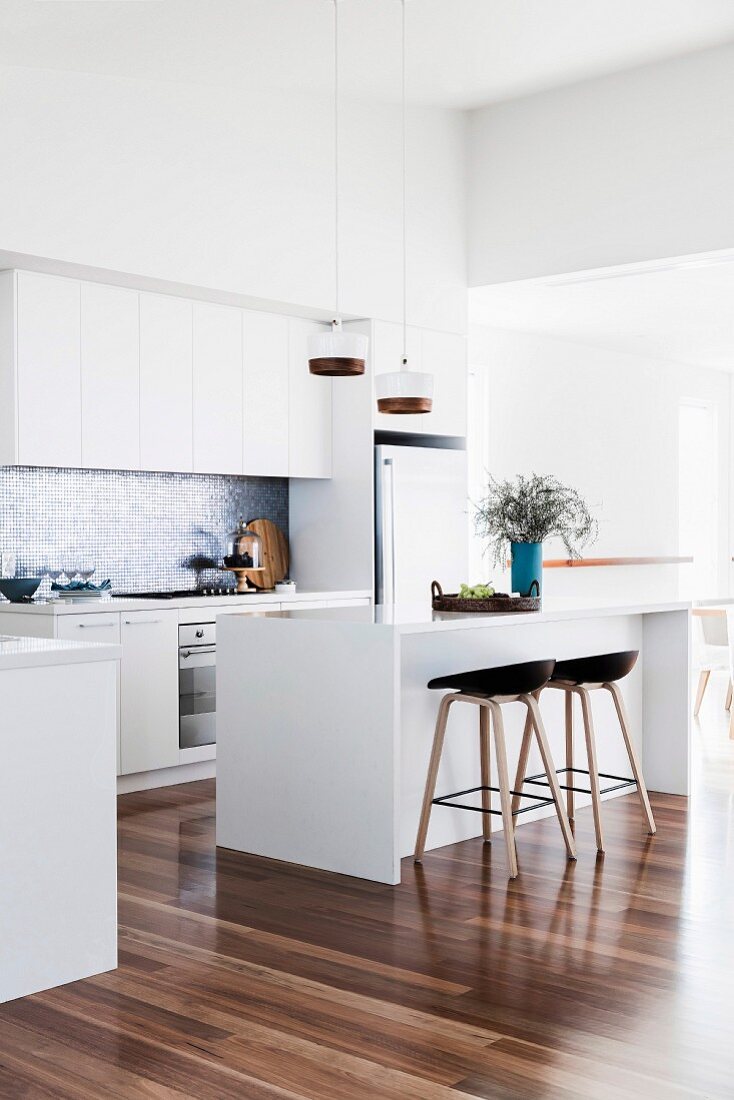 Modern white kitchen with shiny wooden floor