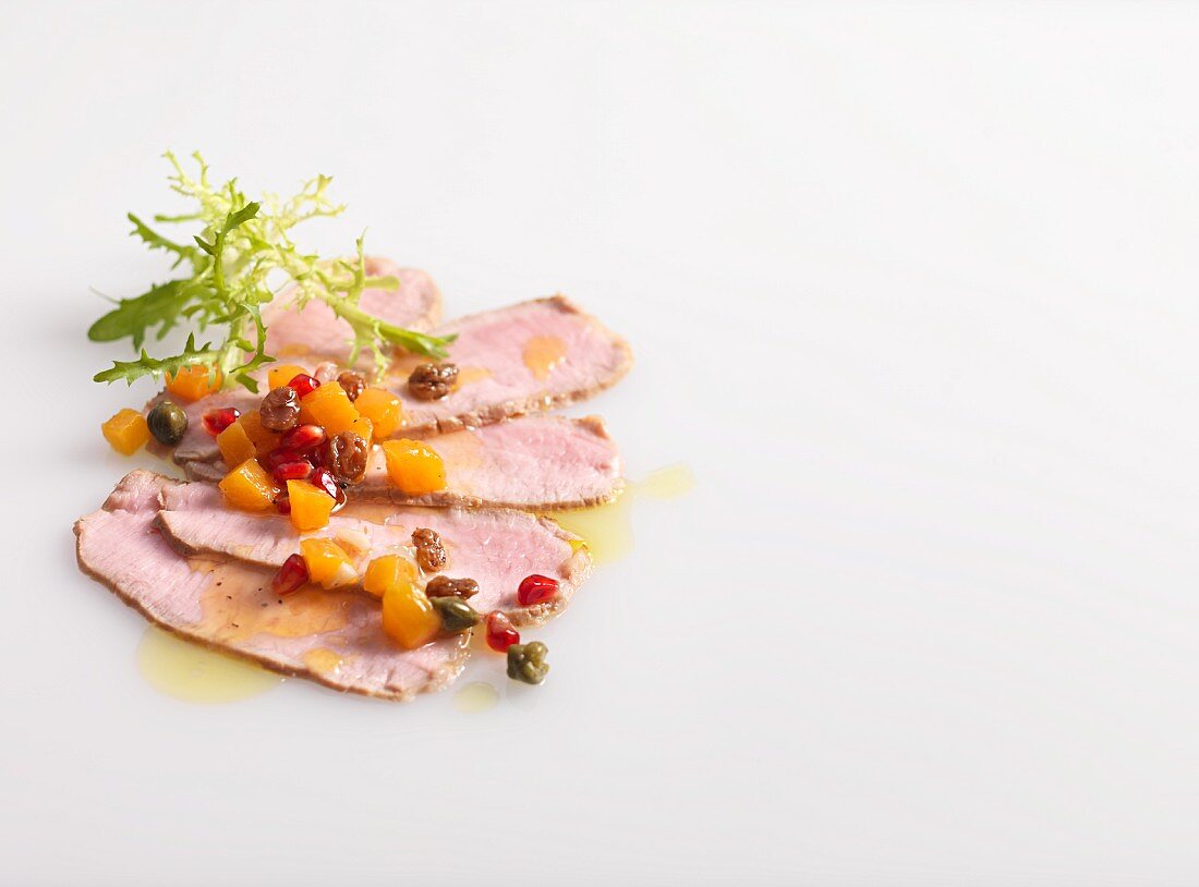 Veal carpaccio on a white background