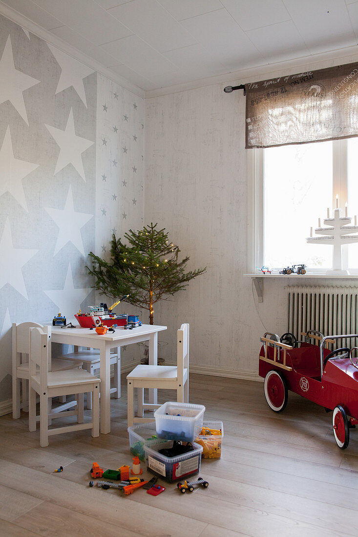 Children's table and chairs and small Christmas tree in child's bedroom