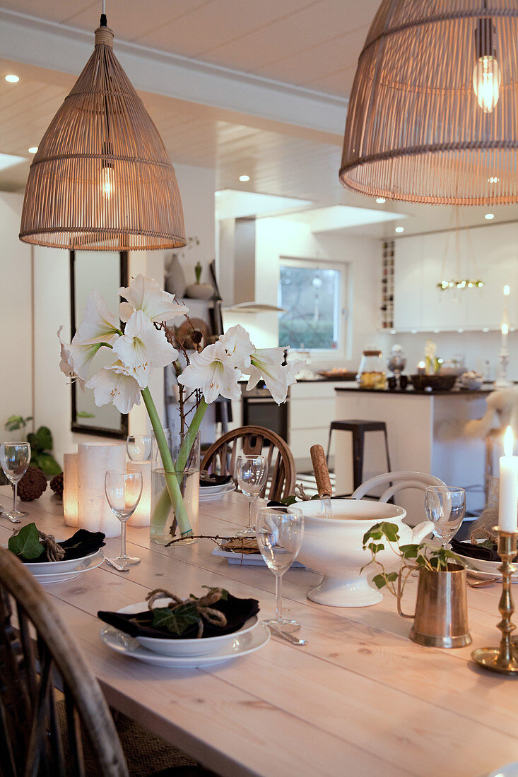 Vase of white amaryllis on table set in classic style