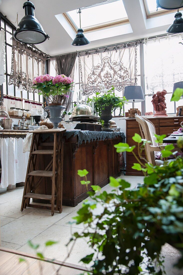 Dresser, lace curtains and modern skylights in vintage kitchen