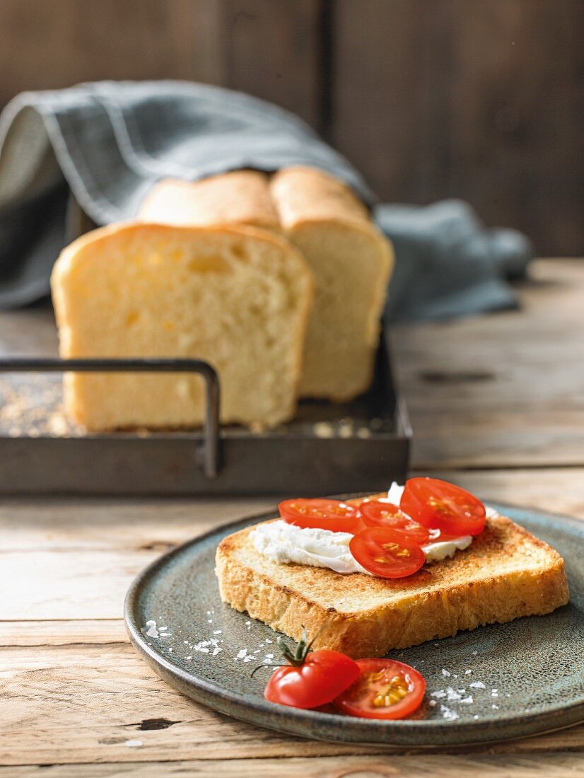 Homemade buttered toast with fresh cheese and tomatoes
