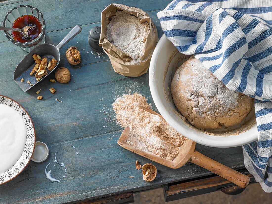 A loaf of bread, flour, barley malt, and walnuts