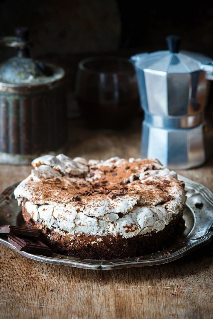 A flourless chocolate cake topped with a nut meringue